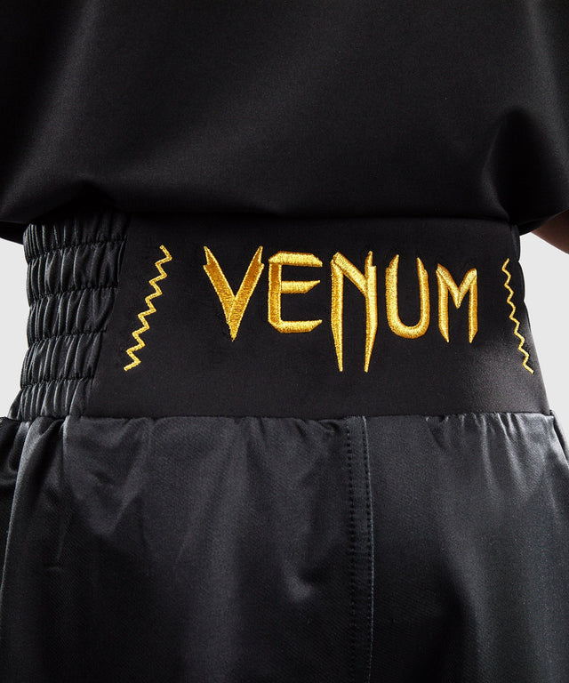 Calções de boxe Venum Attack – Preto/Ouro – Criança